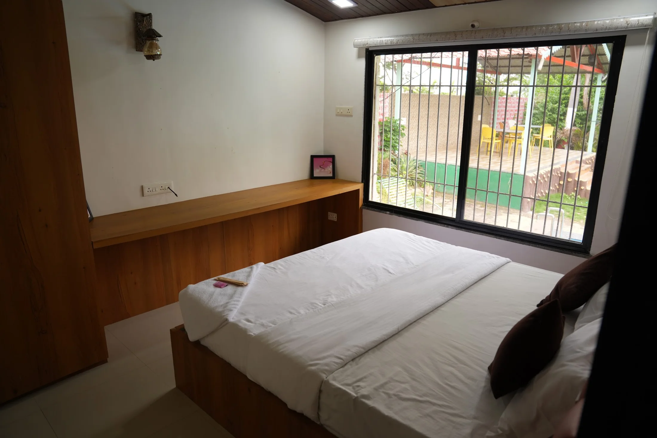 Garden-facing bedroom at DS Agro Tourism & Resort. A second bungalow bedroom overlooking resort greenery.
