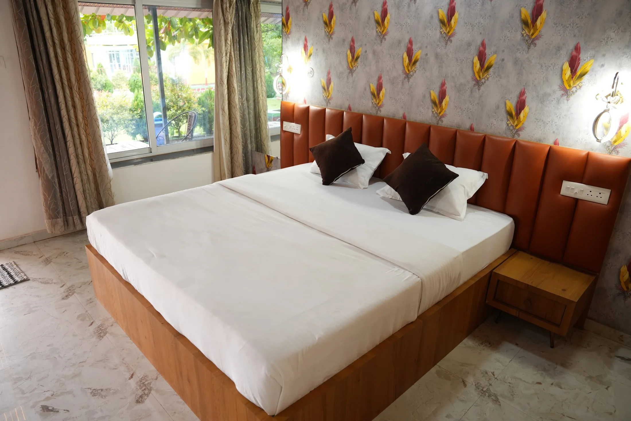 Deluxe king room at DS Agro Tourism & Resort. A bright king-bed room with a garden-facing window.