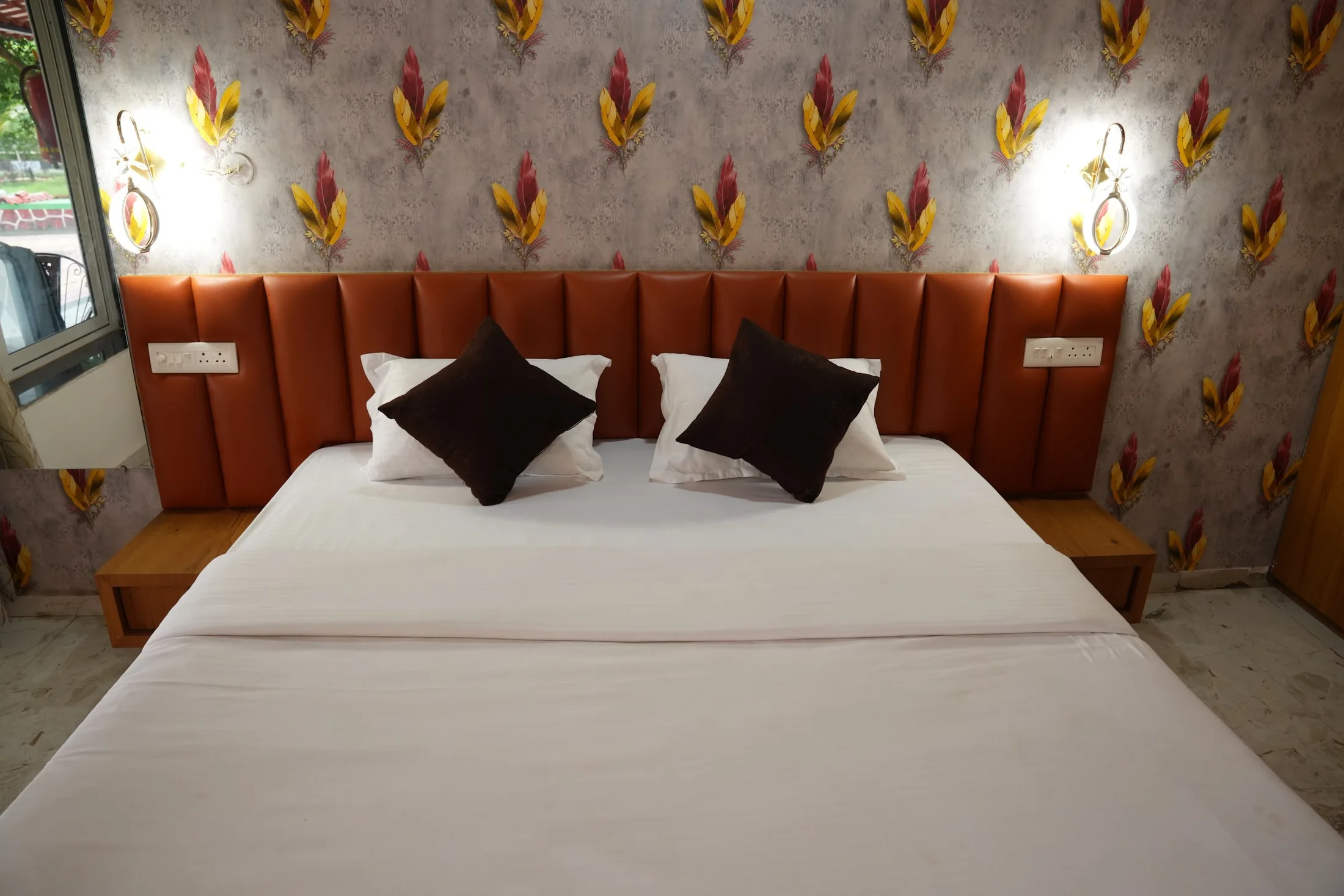 Deluxe king bed at DS Agro Tourism & Resort. A centered view of the king-bed headboard and bedside tables.