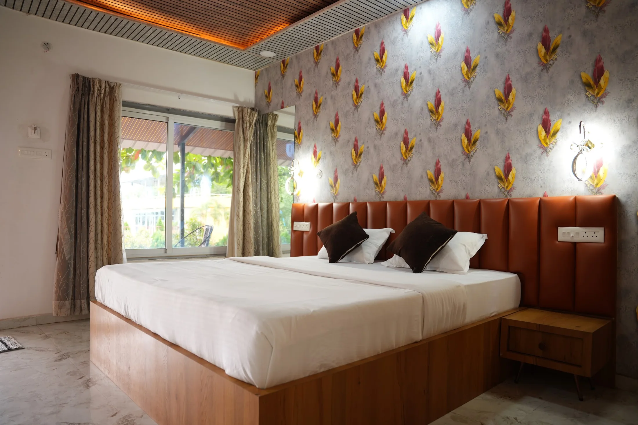 Deluxe bedroom at DS Agro Tourism & Resort. A bright bedroom from the Deluxe room collection.