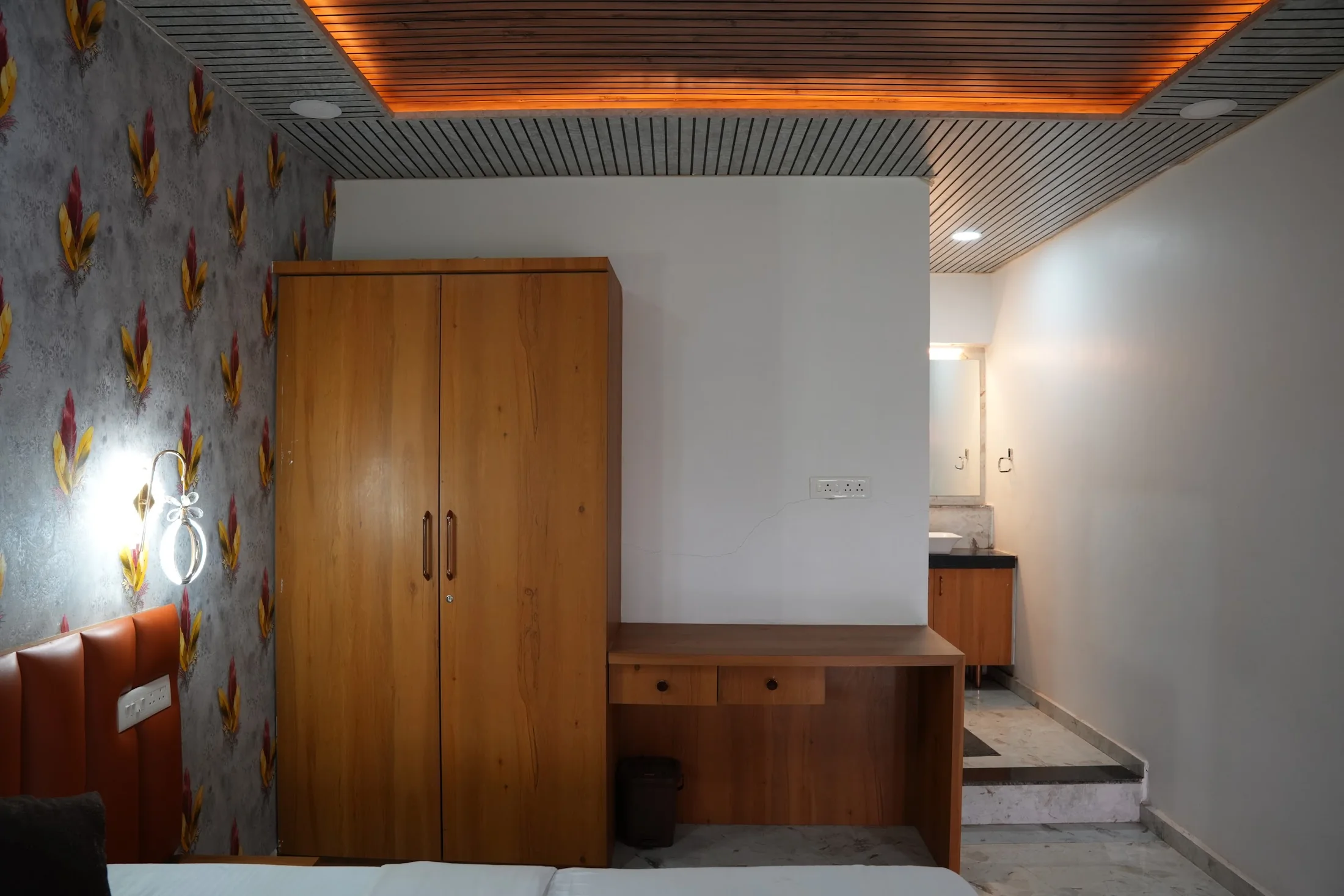 Deluxe room storage at DS Agro Tourism & Resort. Wardrobe, desk and room circulation shown together.