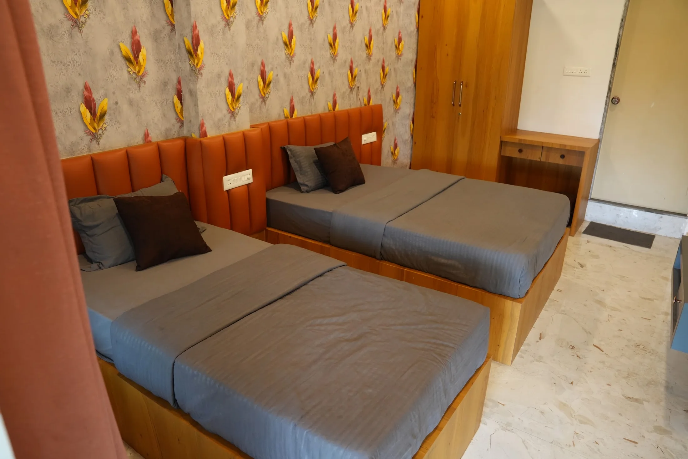 Deluxe twin room at DS Agro Tourism & Resort. A twin-bed configuration photographed from the entrance.