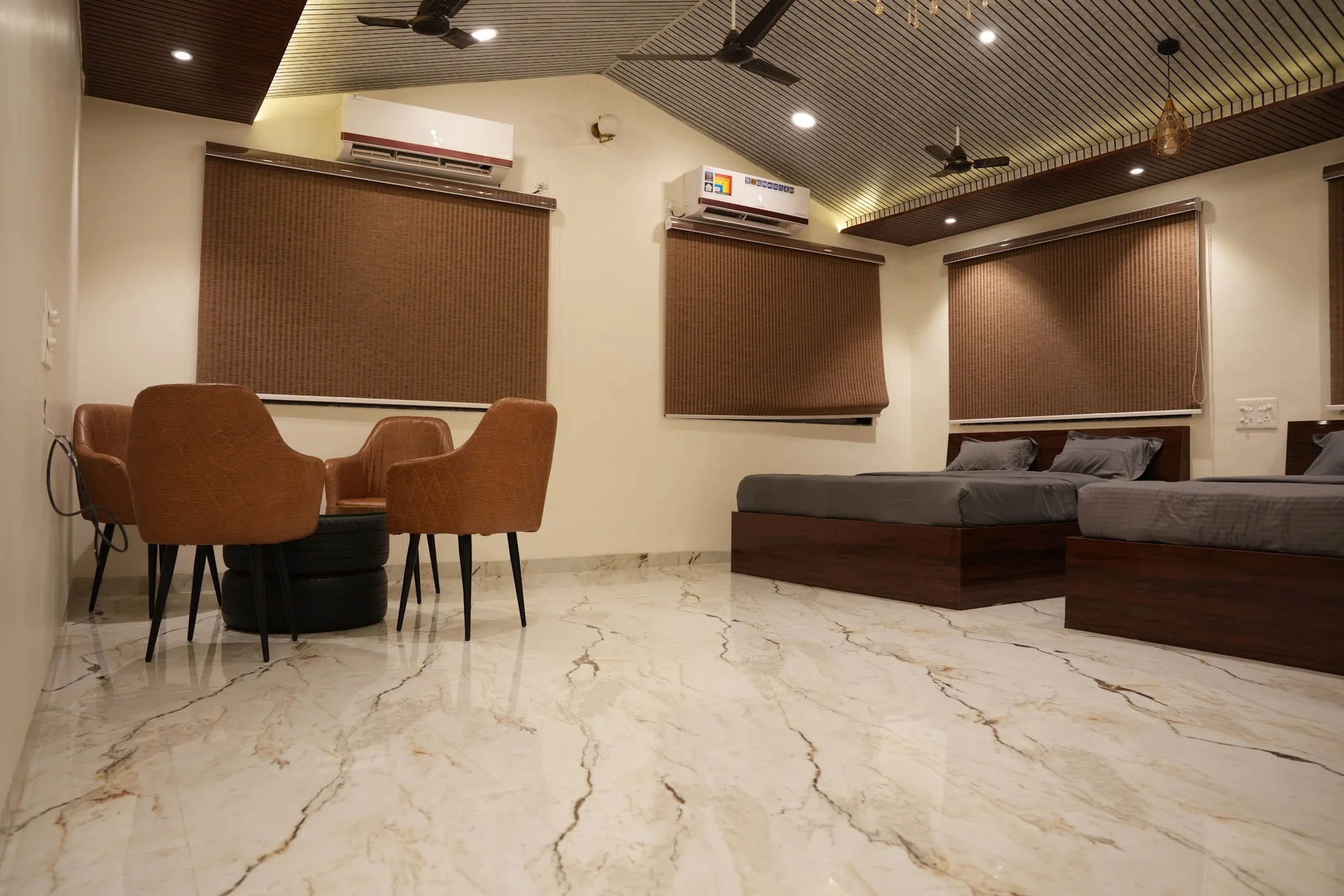Premium seating and beds at DS Agro Tourism & Resort. The seating area and bedroom layout viewed together.