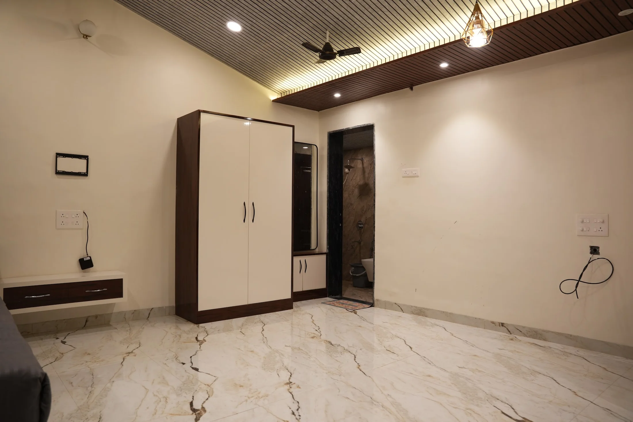 Premium storage at DS Agro Tourism & Resort. Wardrobe and television wall within the Premium room.