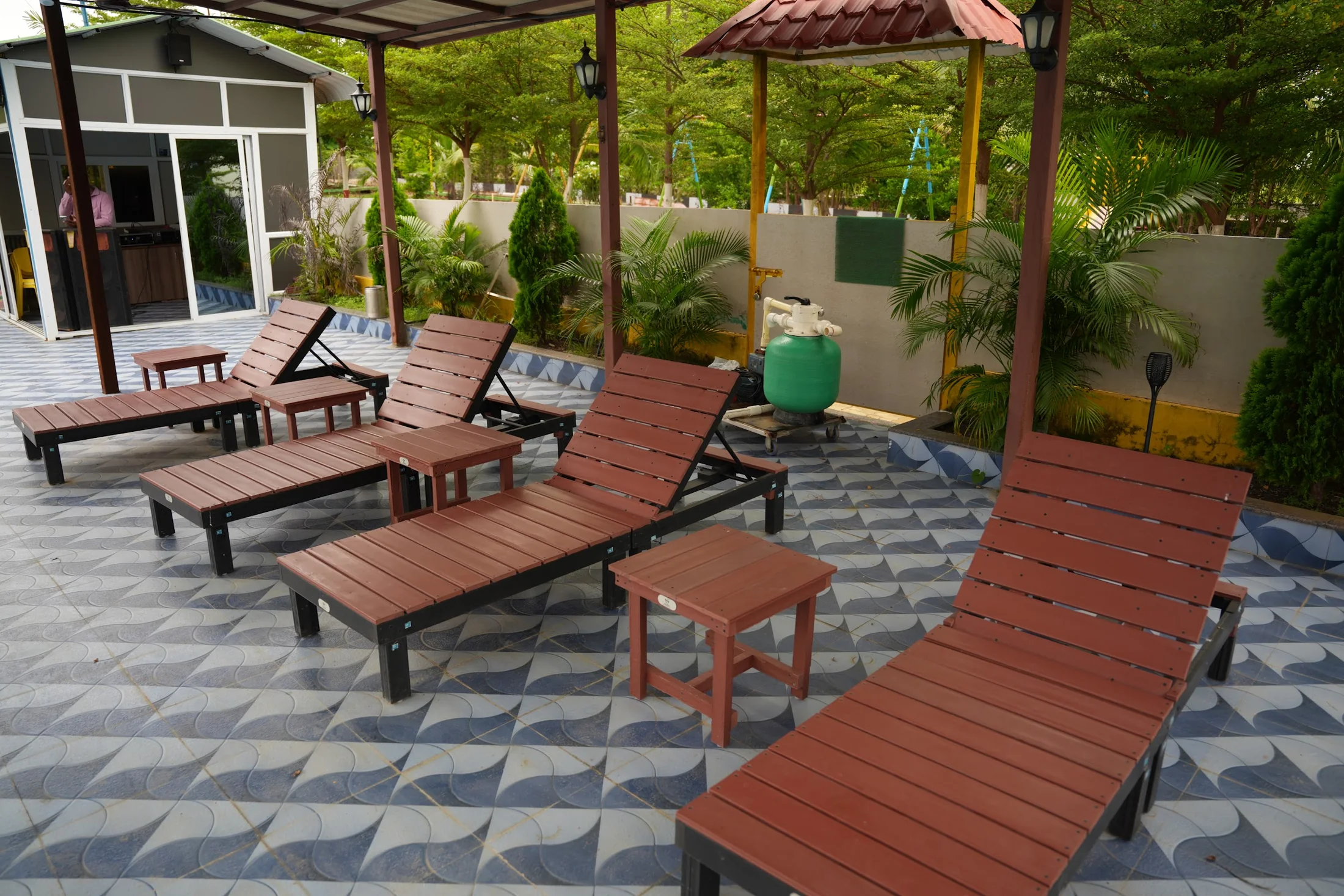 Pool deck. Covered loungers and seating beside the main swimming pool.