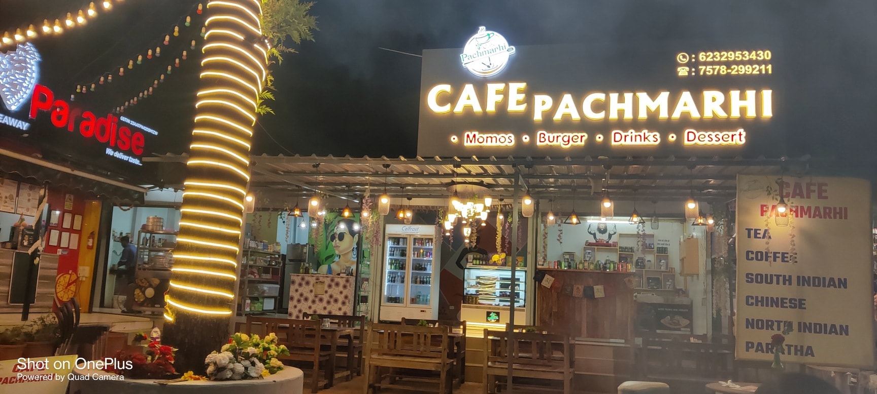 Cafe Pachmarhi illuminated storefront in the evening