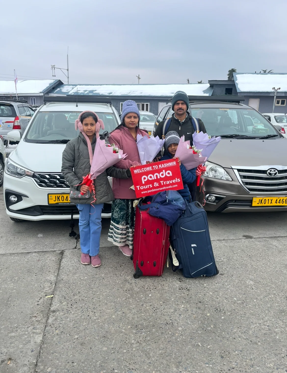 A family welcomed at Srinagar airport with flowers by Panda Tours and Travels