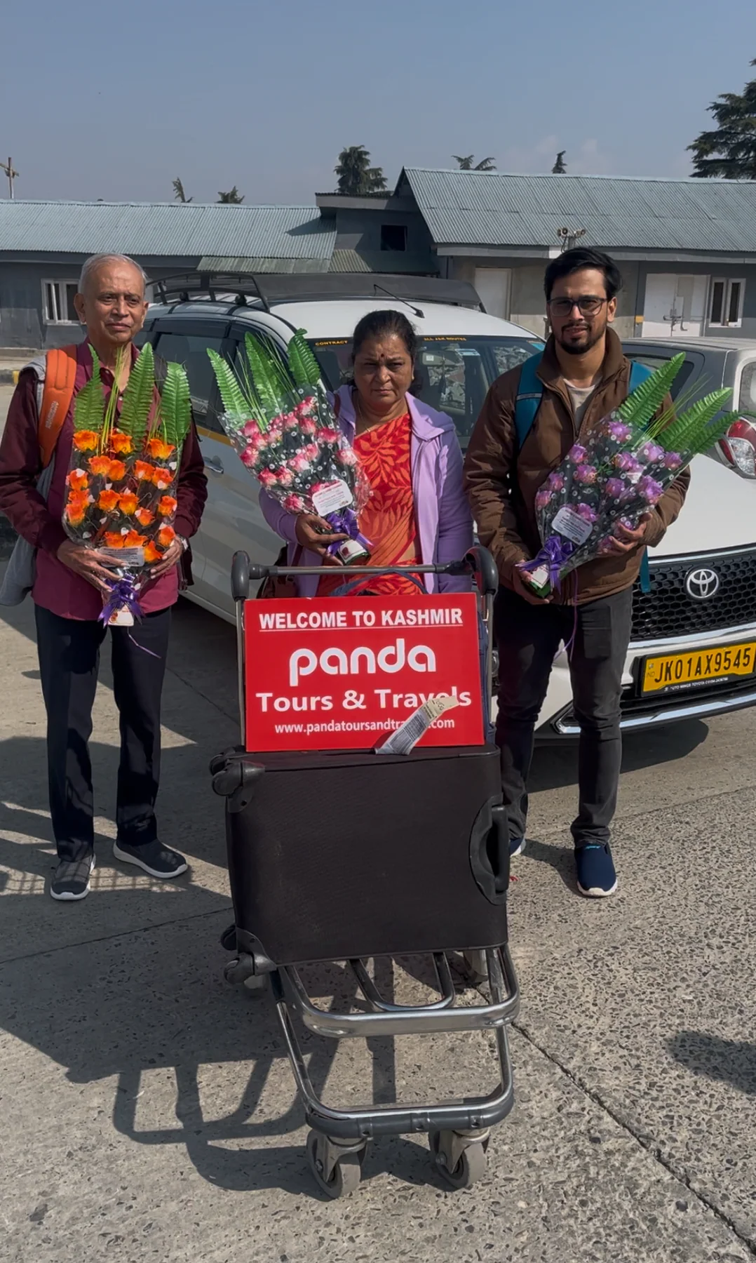 Three travellers greeted with flower bouquets at Srinagar airport